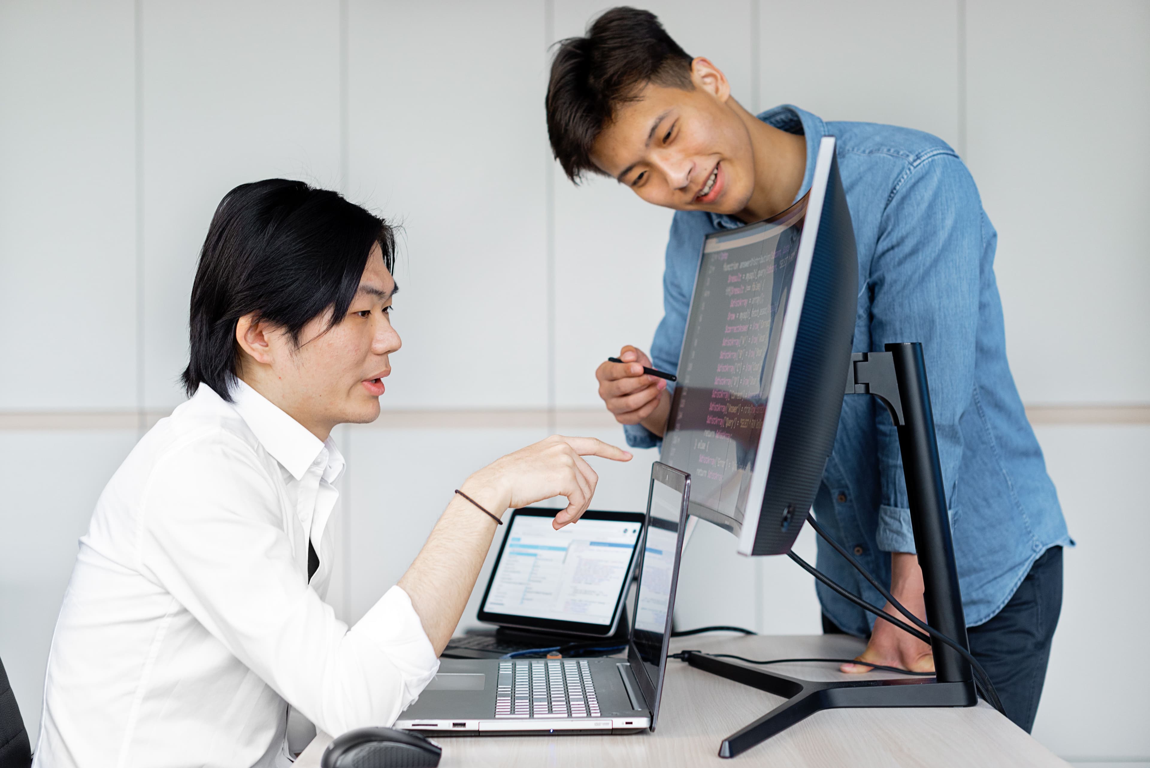 Technology professionals collaborating at a computer workstation
