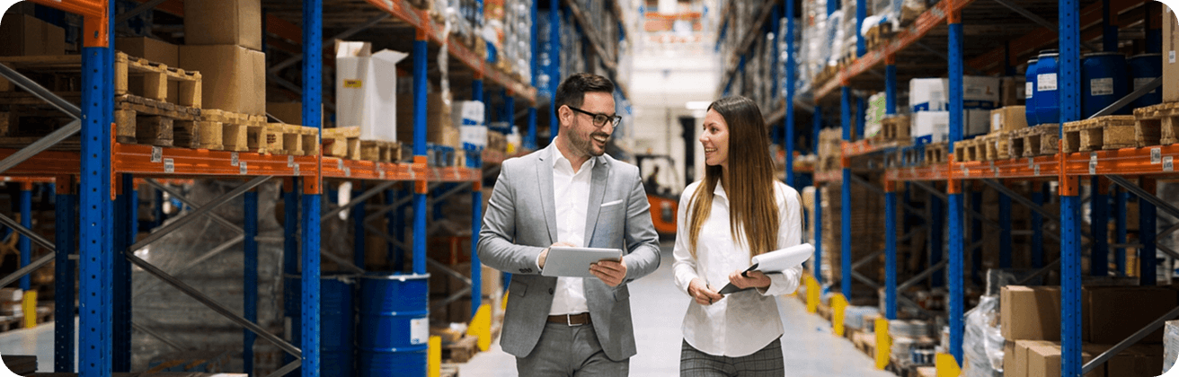 Retail and distribution colleagues discussing operations in a warehouse.
