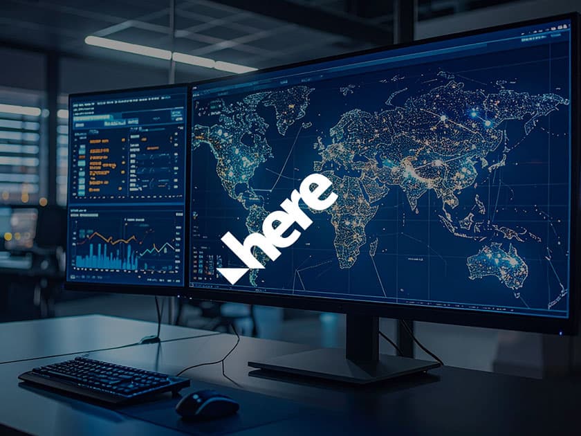 HERE Technologies location intelligence dashboard displayed across desktop monitors